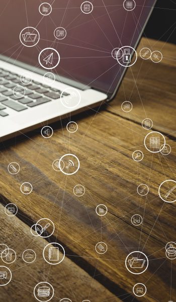 digital composite of laptop with communication graphics